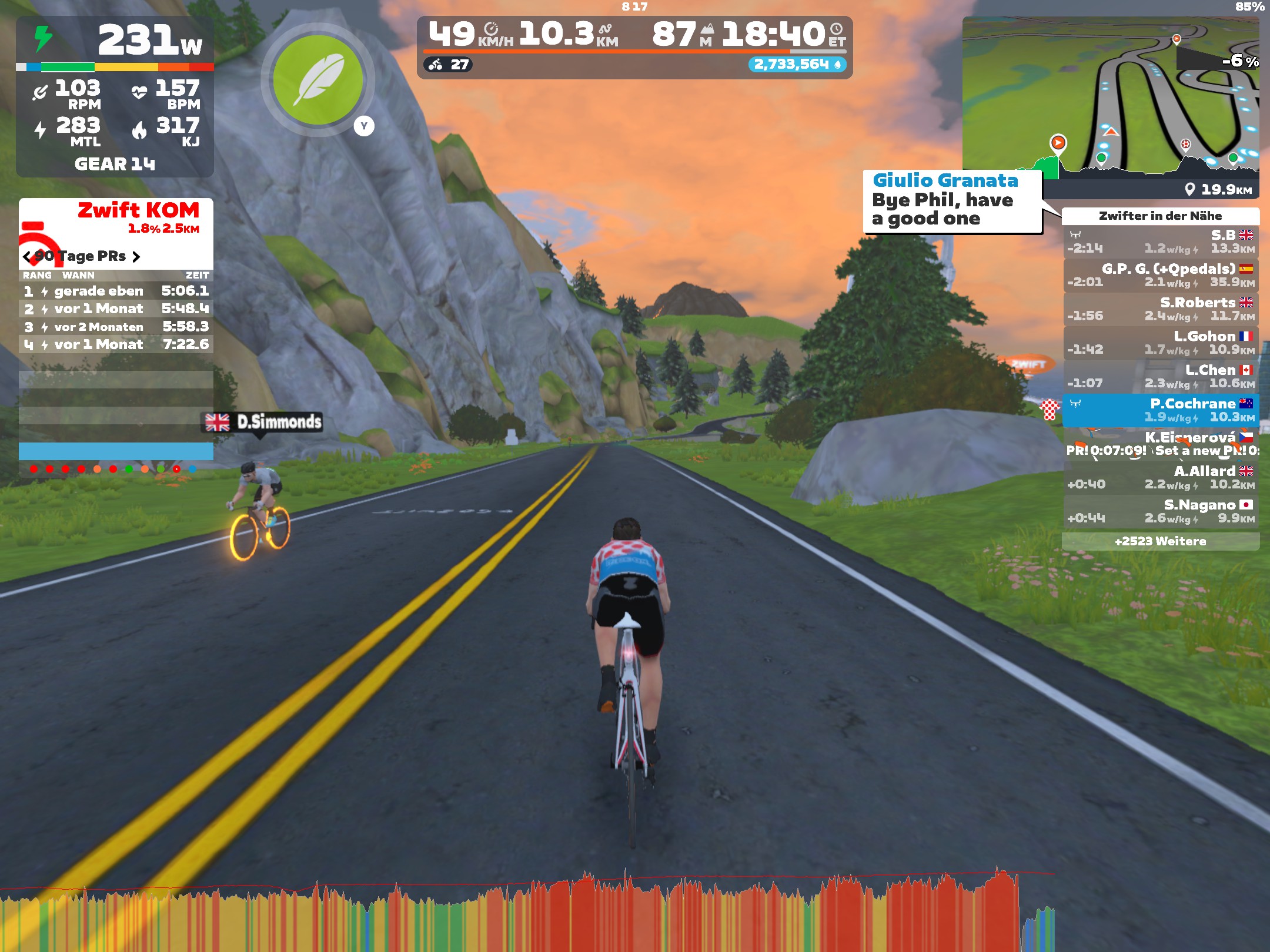 View of cyclist riding along road in Zwift wearing a polka dot jersey